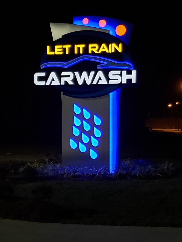 Signage for Let It Rain Car Wash.